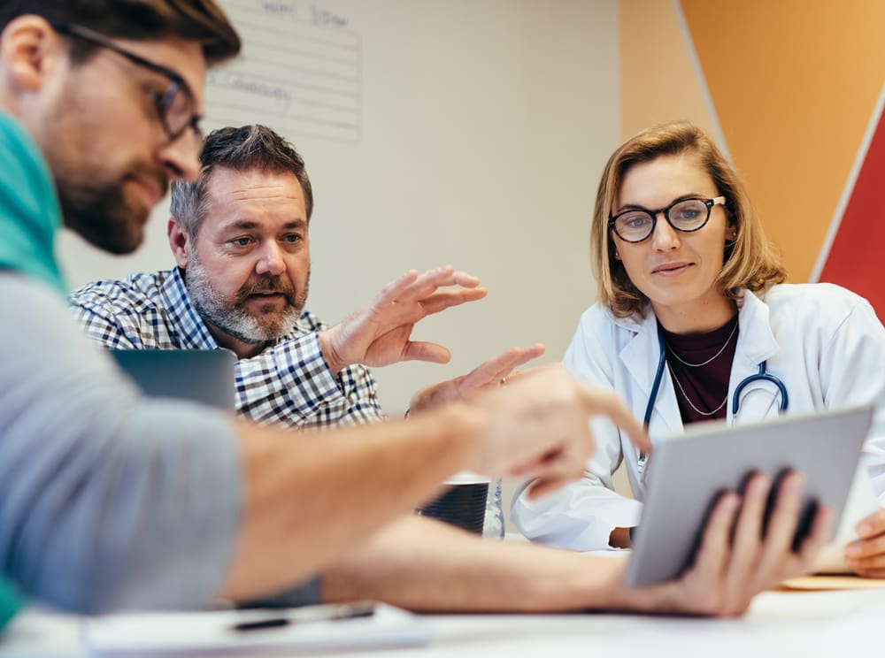 Healthcare business employees discuss strategies.