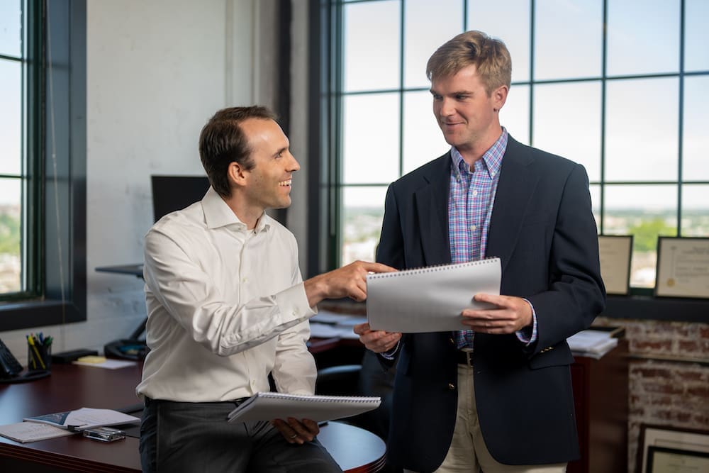 Vice President Andy Spears talking to Senior Analyst Frank Ihle.