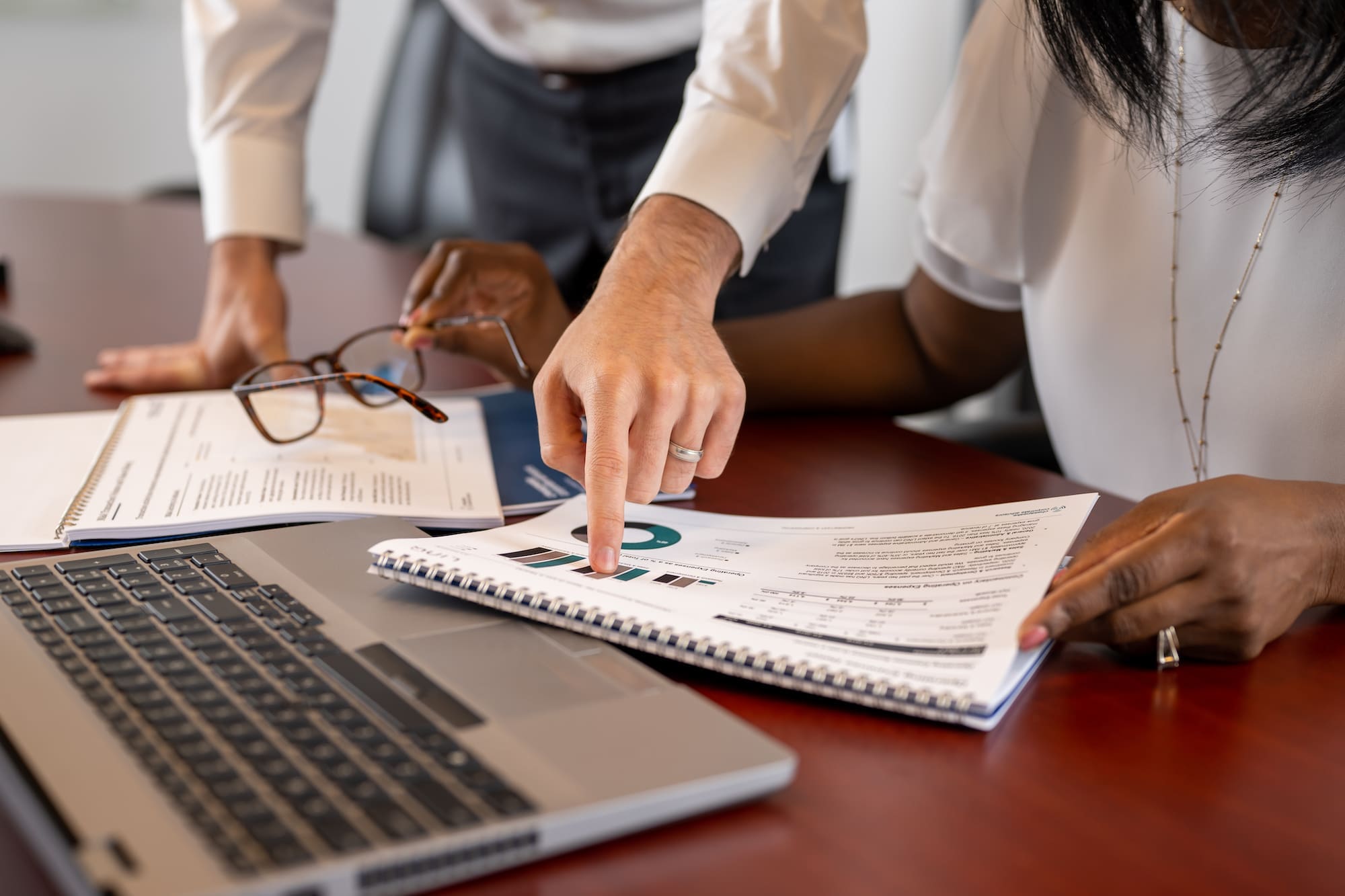 business people pointing at paper