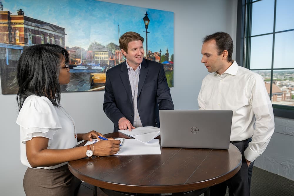 Vice President Andy Spears talking to Managing Director Timothy Brasel and Cheif of Staff Holly Johnson. 